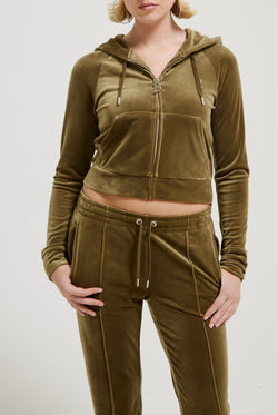 Displays a model wearing the Dark Olive 'Juicy' branded velour diamanté tracksuit bottom