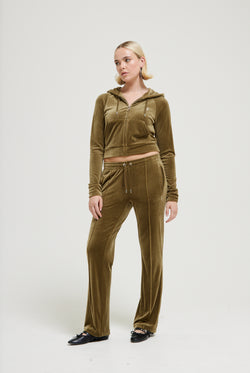 Displays a model wearing the Dark Olive 'Juicy' branded velour diamanté tracksuit bottom