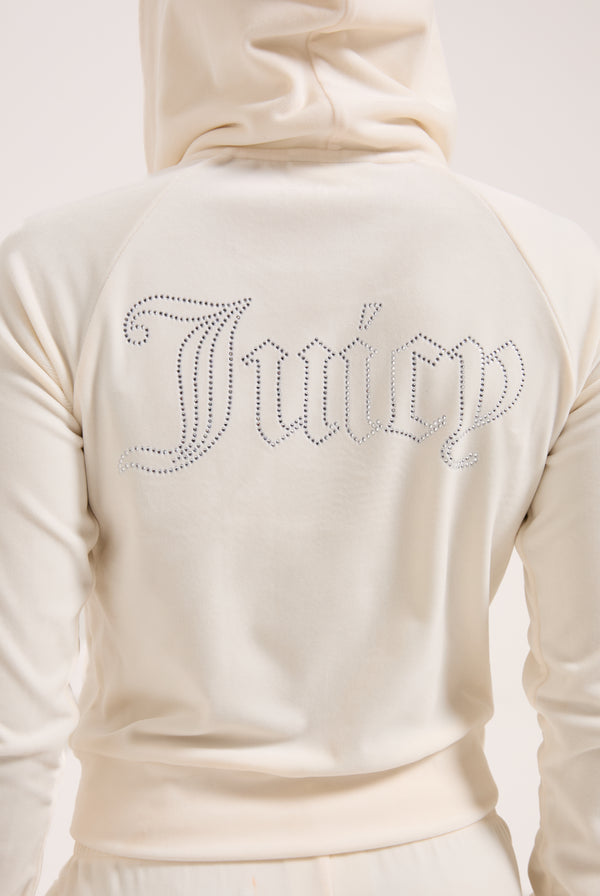Displays a model wearing the cream 'juicy' branded cream outline diamanté velour zip-through hoodie 