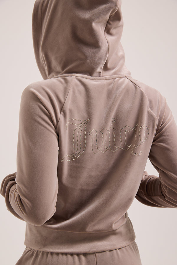 Displays a model wearing the fungi outline 'Juicy' branded diamanté velour zip-through hoodie 