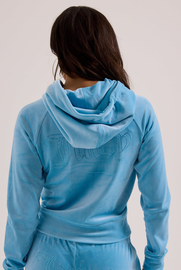 Displays a model wearing the sky blue outline 'juicy' branded velour zip-through hoodie 