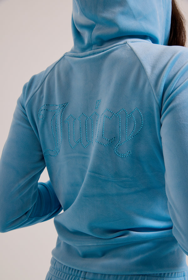 Displays a model wearing the sky blue outline 'juicy' branded velour zip-through hoodie 