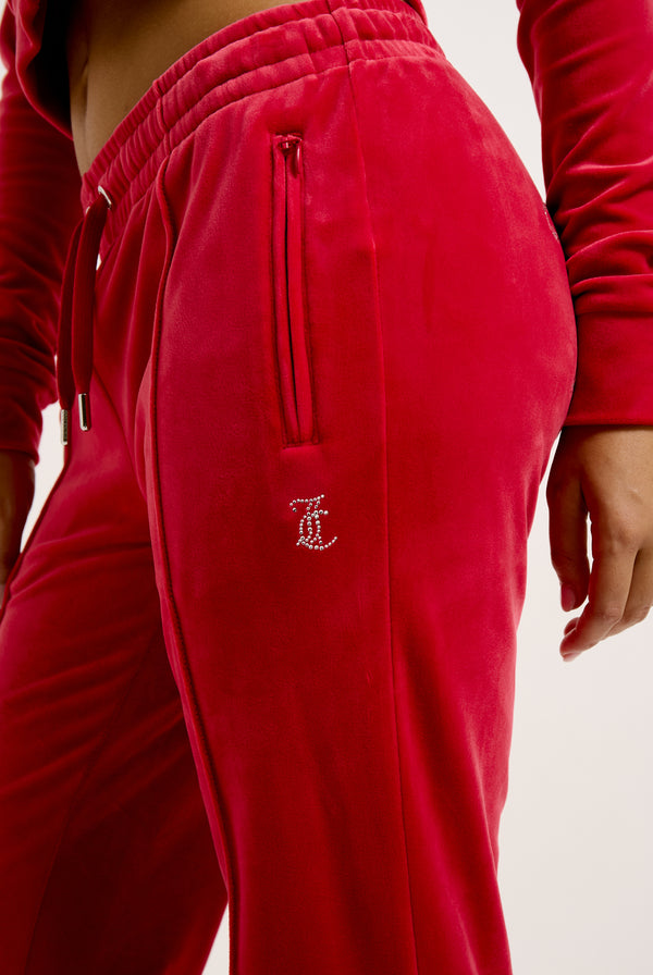 Displays the Astor Red Velour 'Juicy' branded Diamanté tracksuit bottoms 