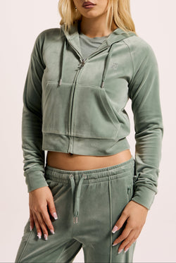 Displays a model wearing the Chinois Green 'Juicy' branded diamanté velour zip-through hoodie 