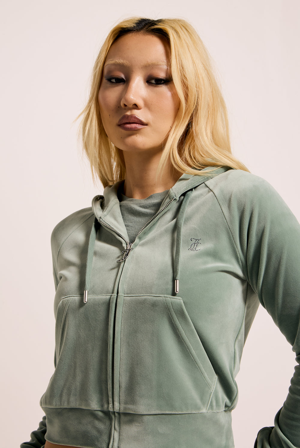 Displays a model wearing the Chinois Green 'Juicy' branded diamanté velour zip-through hoodie 
