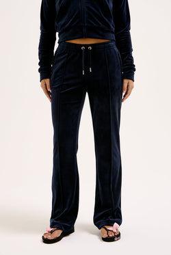 Displays a model wearing the Night Sky 'juicy' branded velour diamanté tracksuit bottom