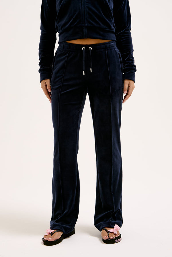 Displays a model wearing the Night Sky 'juicy' branded velour diamanté tracksuit bottom