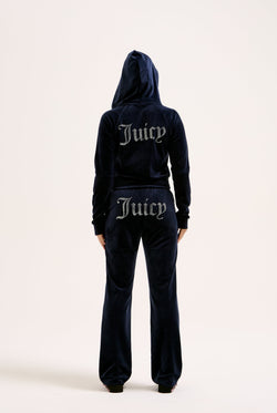 Displays a model wearing the Night Sky 'juicy' branded velour diamanté tracksuit bottom