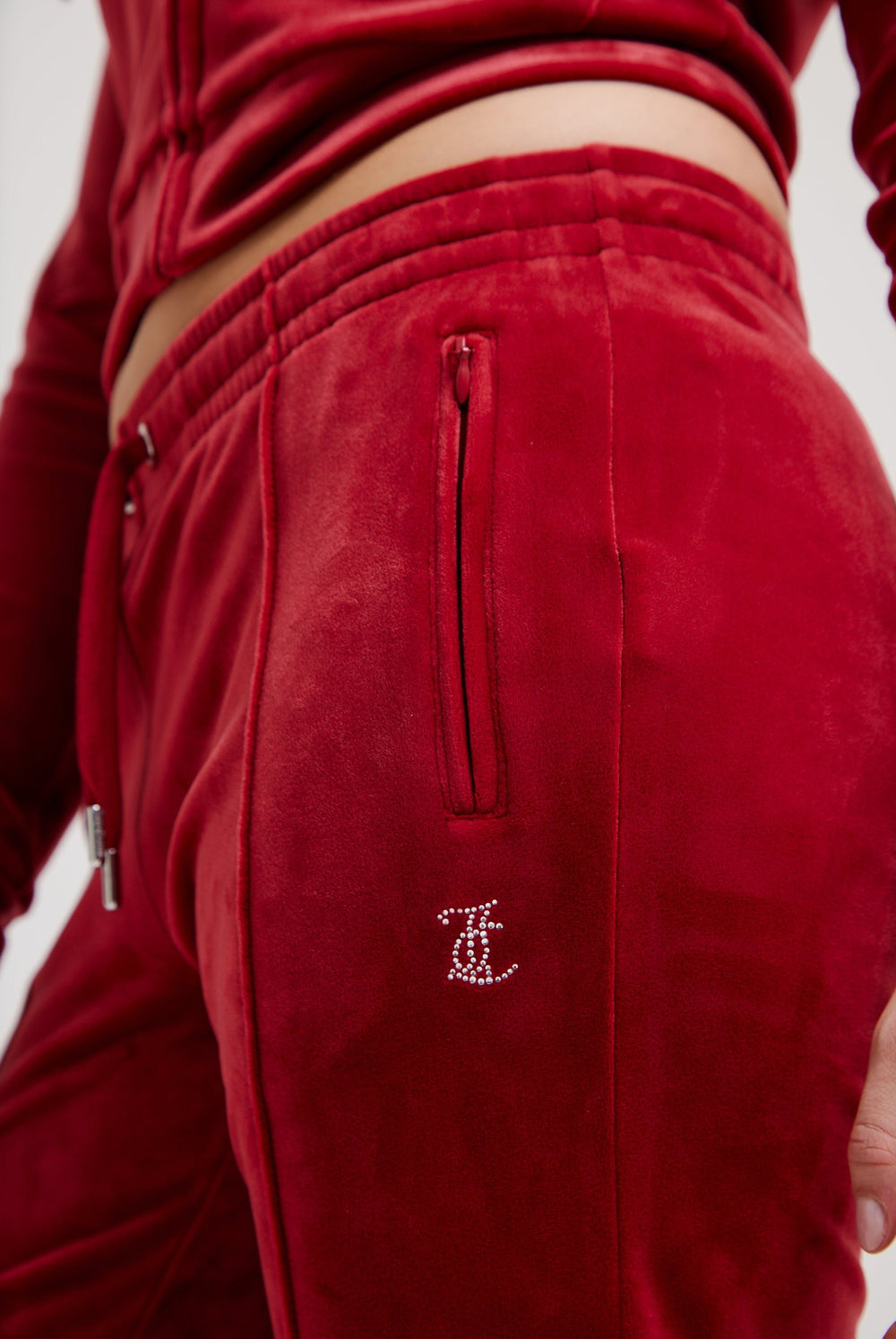 Displays the Red Dahlia 'Juicy' branded velour diamanté tracksuit bottom