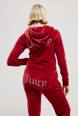 Displays a model wearing the Red Dahlia 'Juicy' branded velour diamanté tracksuit bottom