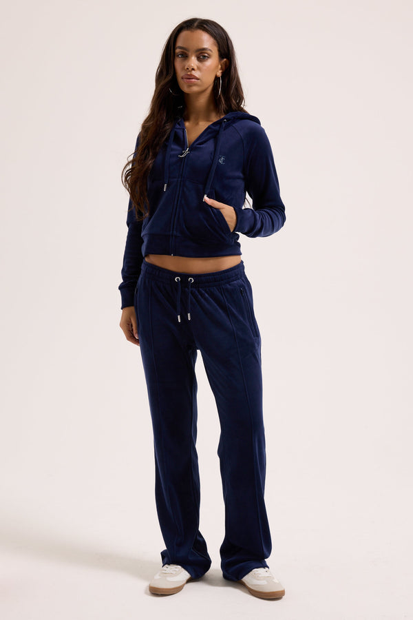 Displays a model wearing the Night Sky outline 'Juicy' branded velour diamanté tracksuit bottom 