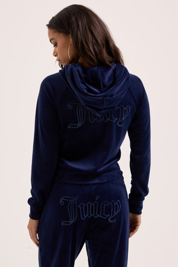 Displays a model wearing the Night Sky outline 'Juicy' branded velour diamanté tracksuit bottom 
