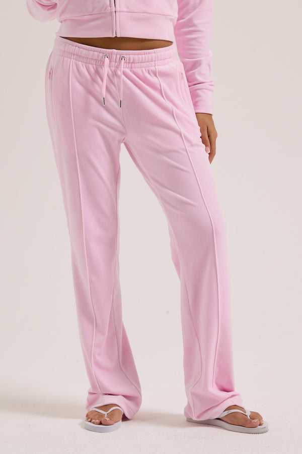 Displays a model wearing the Cherry Blossom 'Juicy' branded velour outline diamanté tracksuit bottom  