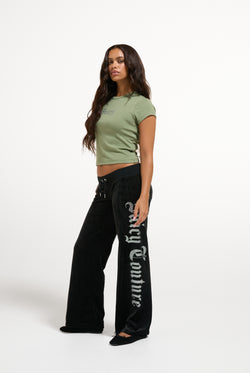 Displays a model wearing the Oil Green 'Juicy' branded Old Gothic Baby T-Shirt