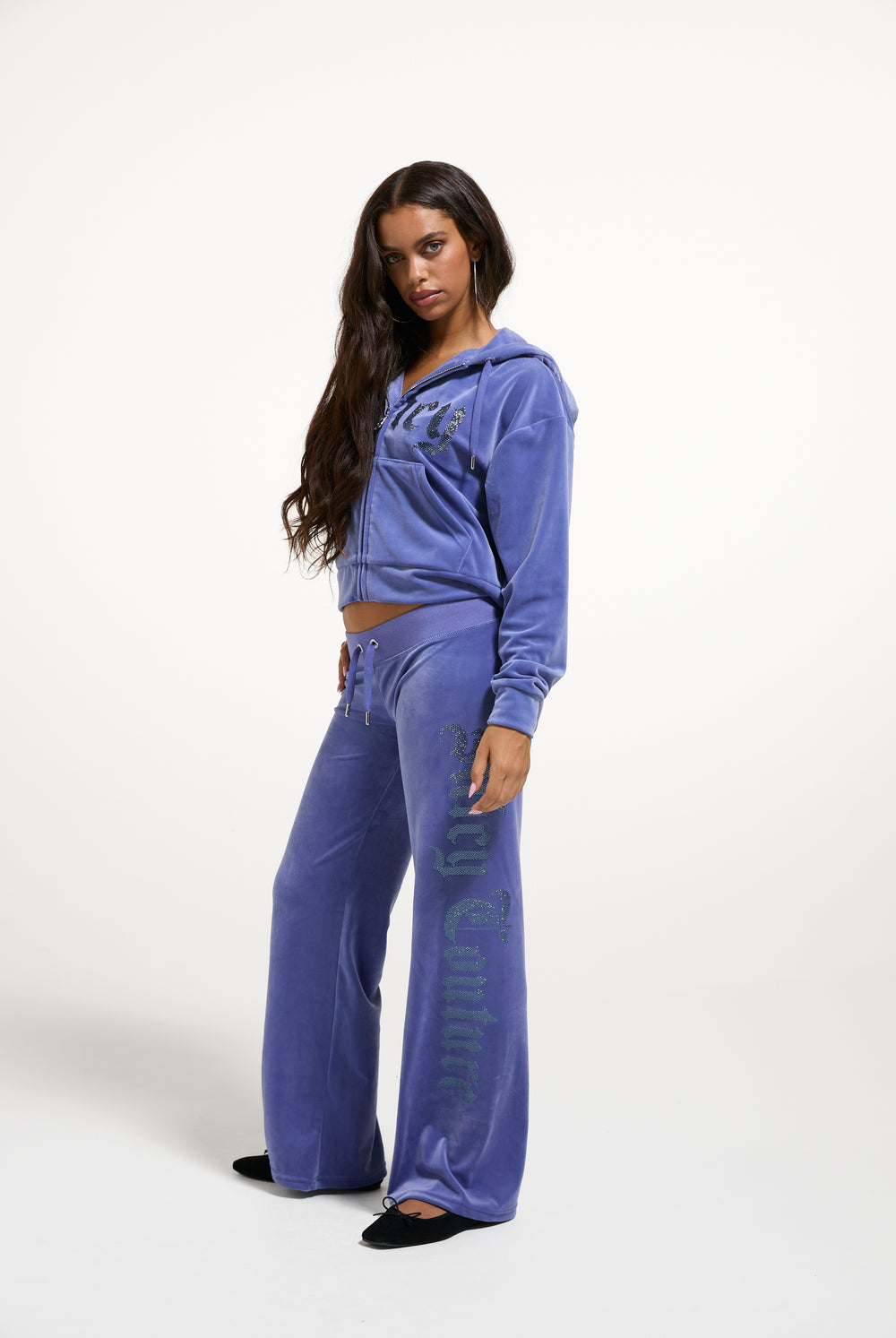 Displays a model wearing the Greyblue 'Juicy' branded Old Gothic Diamante OG Straight Leg Trackpant