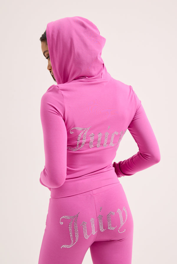 Displays a model wearing the super pink 'juicy' branded diamanté luxury jersey low rise pant 