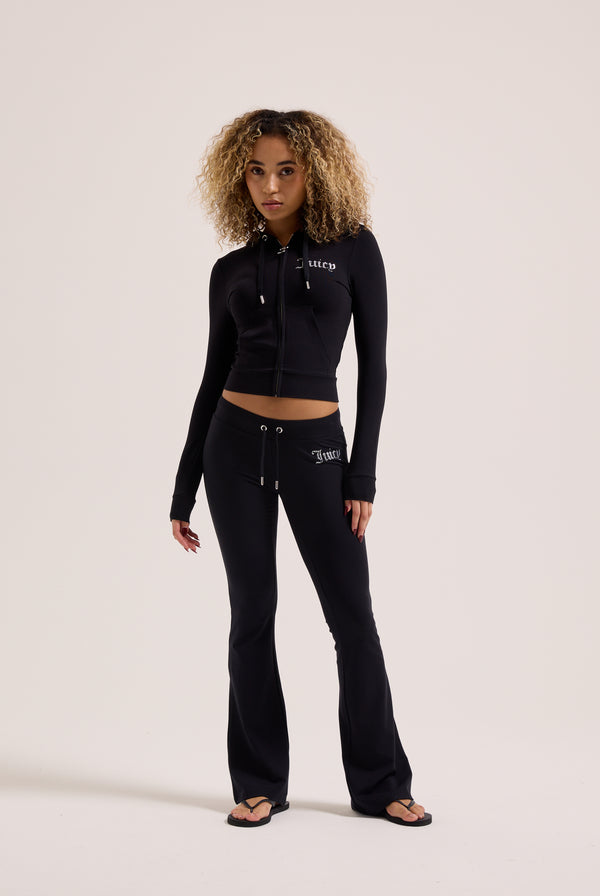 Displays a model wearing the Black 'Juicy' branded diamanté luxury jersey zip-through hoodie