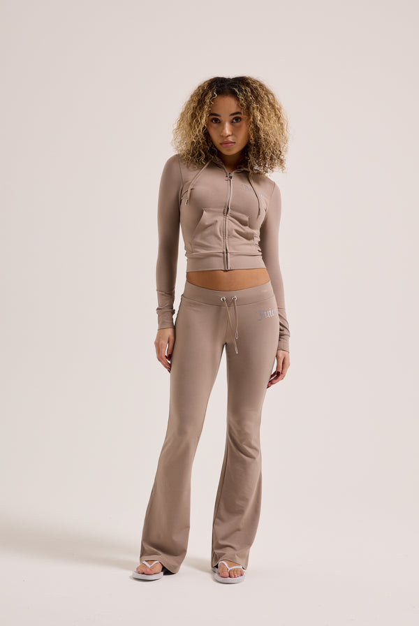 Displays a model wearing the Fungi 'juicy' branded diamanté luxury jersey low rise pant 