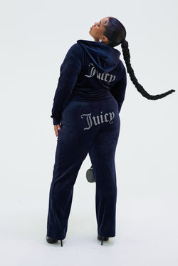 Displays a model wearing the Night Sky 'juicy' branded velour diamanté tracksuit bottom