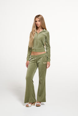 Displays a model wearing the Oil Green 'Juicy' branded Regal Rebelle Caisa Ultra Low Rise Pant