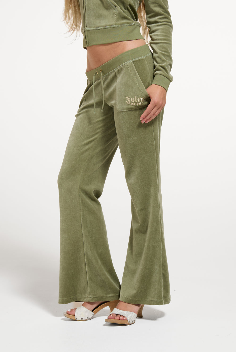 Displays a model wearing the Oil Green 'Juicy' branded Regal Rebelle Caisa Ultra Low Rise Pant