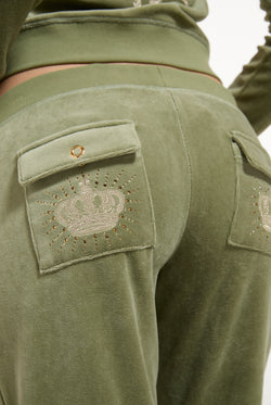 Displays a model wearing the Oil Green 'Juicy' branded Regal Rebelle Caisa Ultra Low Rise Pant