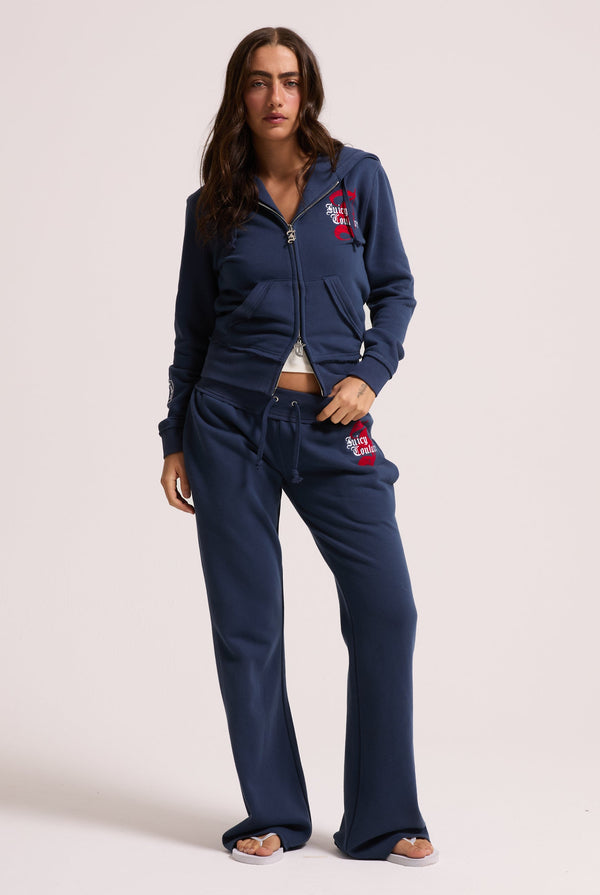 Displays a model wearing the Mood indigo 'juicy' branded longline fleece zip through hoodie 