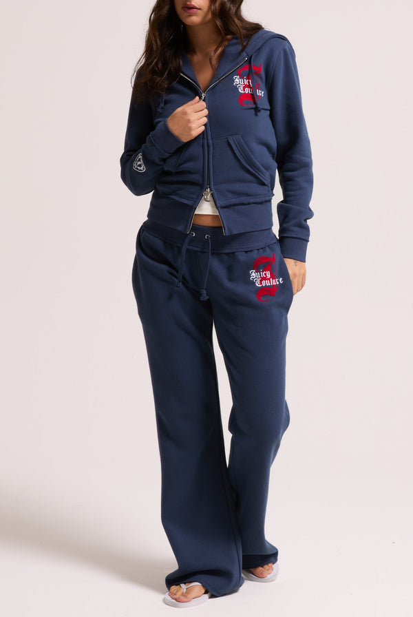 Displays a model wearing the Mood indigo 'juicy' branded longline fleece zip through hoodie 
