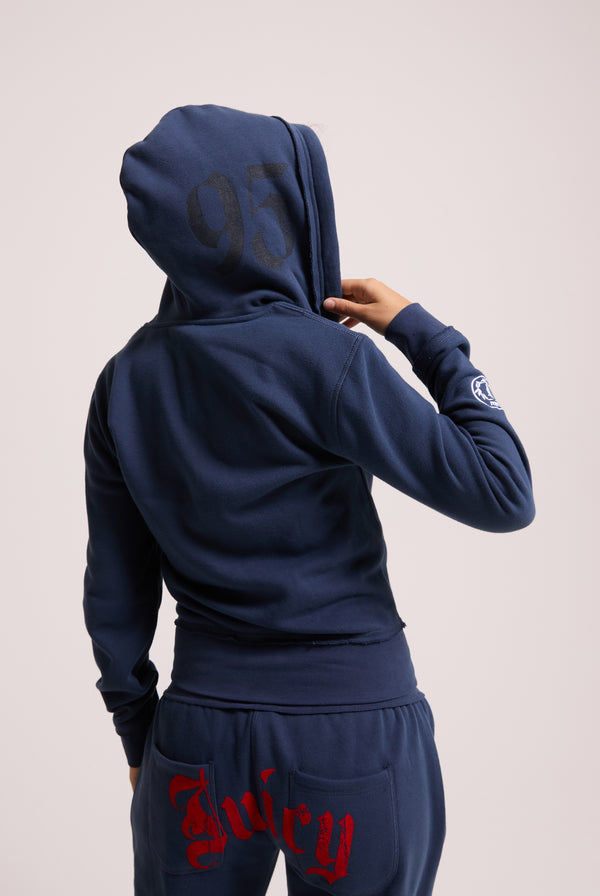 Displays a model wearing the Mood indigo 'juicy' branded longline fleece zip through hoodie 
