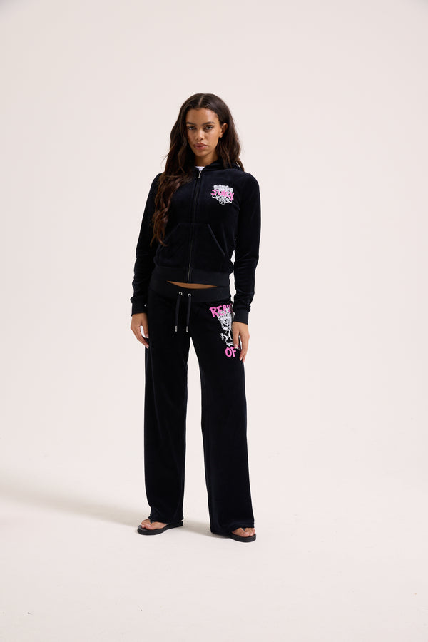 Displays a model wearing the Black Juicy Couture & Roxy Republic of heritage hoodie 