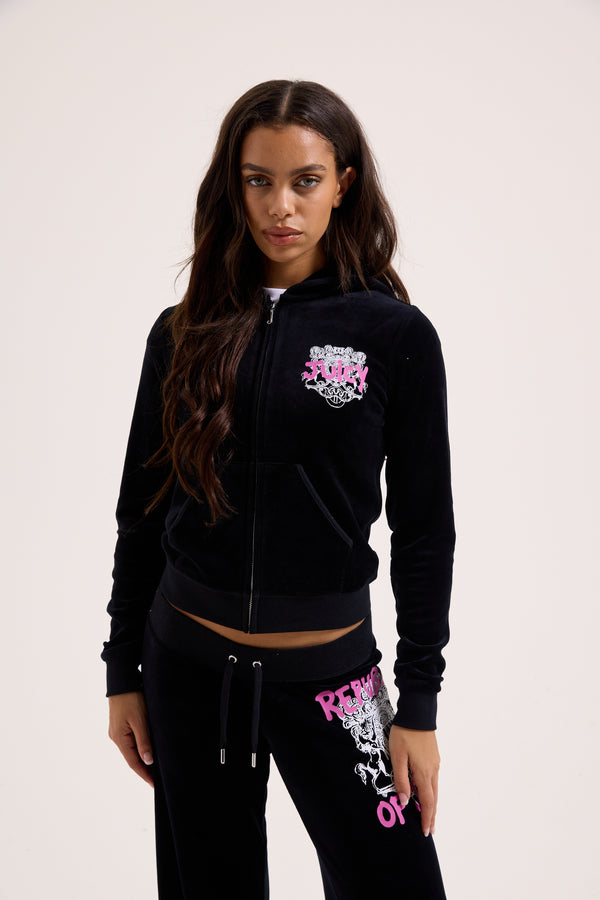 Displays a model wearing the Black Juicy Couture & Roxy Republic of heritage hoodie 