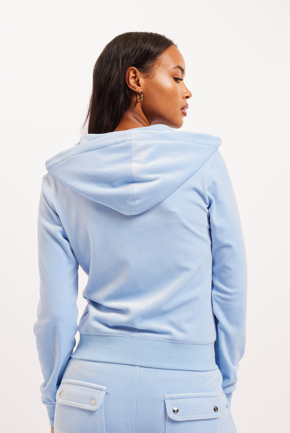 Displays a model wearing the Powder blue classic 'Juicy' branded velour del ray pocketed bottoms 