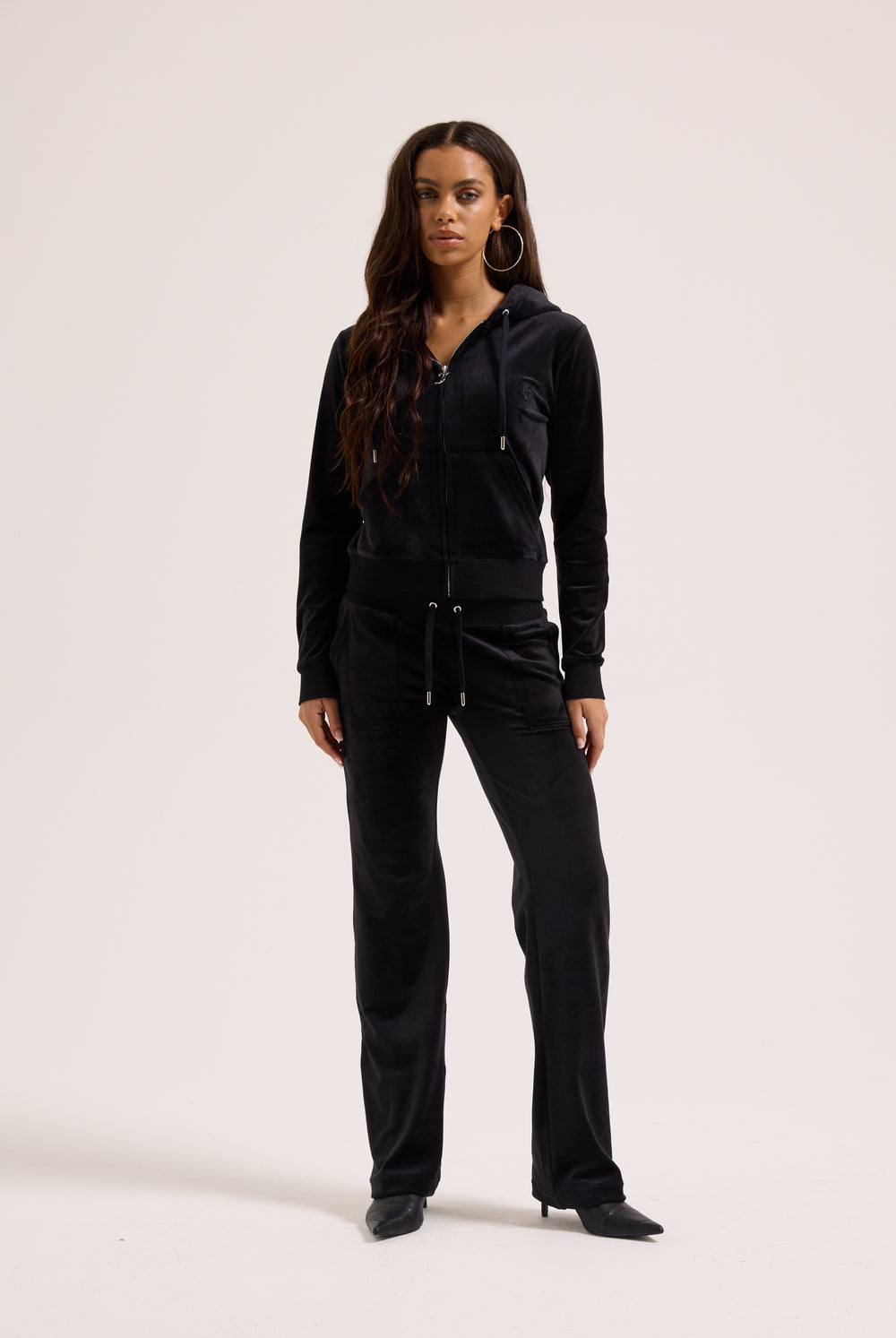 Woman wearing a black outfit on a white background