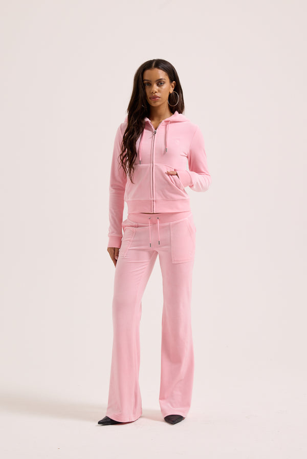 Displays a model wearing the Pink Classic 'Juicy' branded Velour Robertson Hoodie 