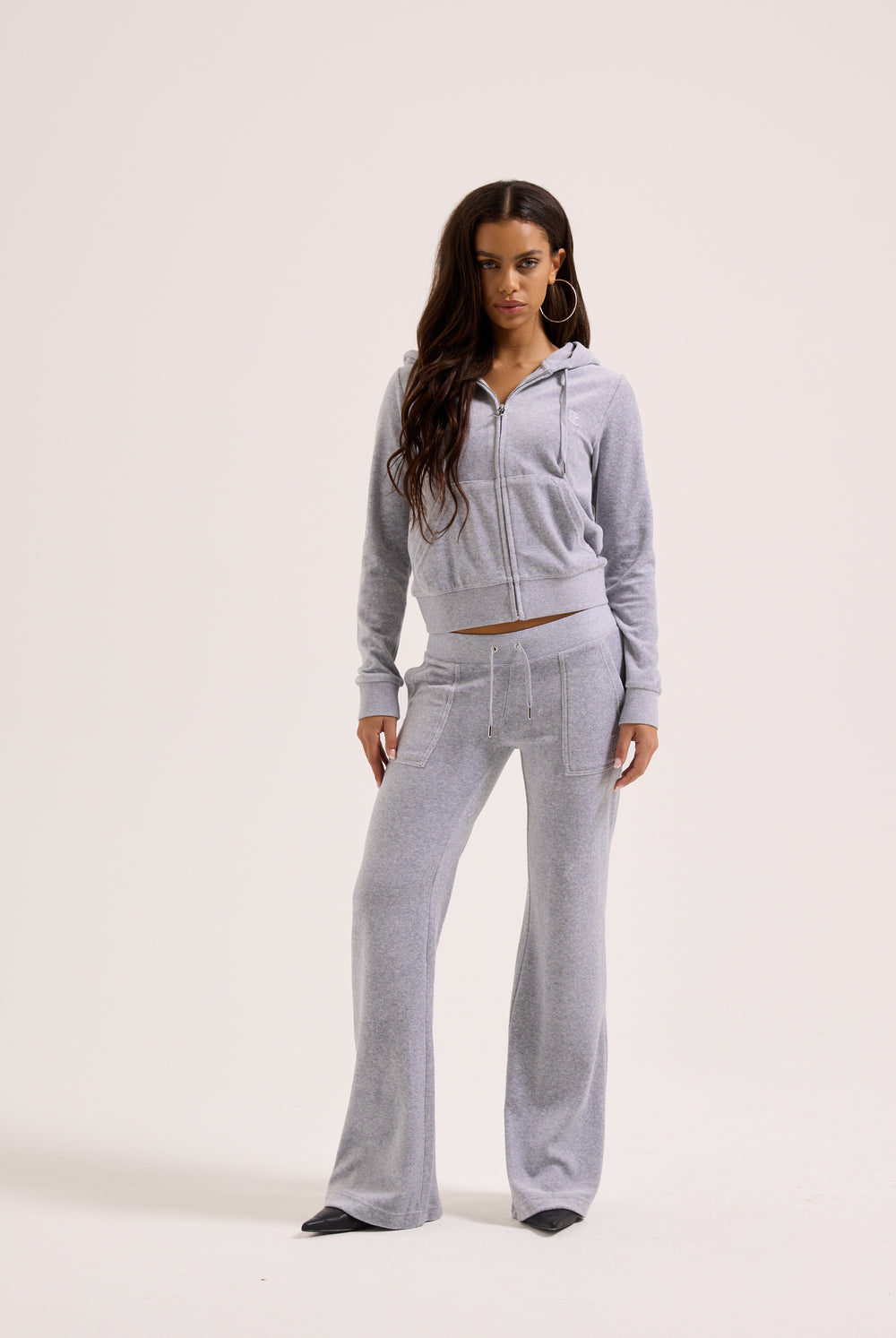 Displays a model wearing the Silver Marl Low Rise 'Juicy' branded cotton velour track pants