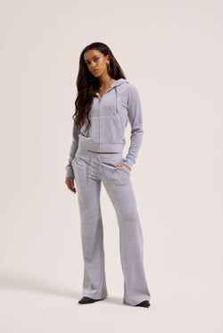 Displays a model wearing the Silver Marl Low Rise 'Juicy' branded cotton velour track pants