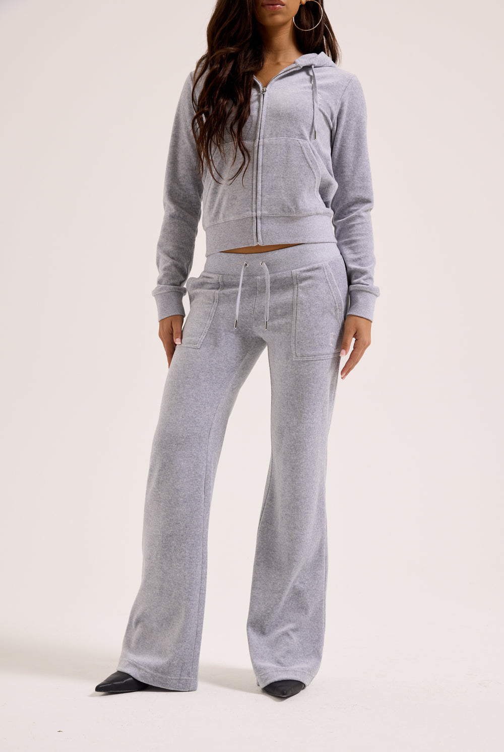 Displays a model wearing the Silver Marl Low Rise 'Juicy' branded cotton velour track pants