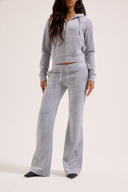 Displays a model wearing the Silver Marl Low Rise 'Juicy' branded cotton velour track pants