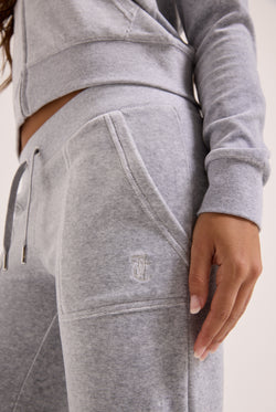 Displays a model wearing the Silver Marl Low Rise 'Juicy' branded cotton velour track pants