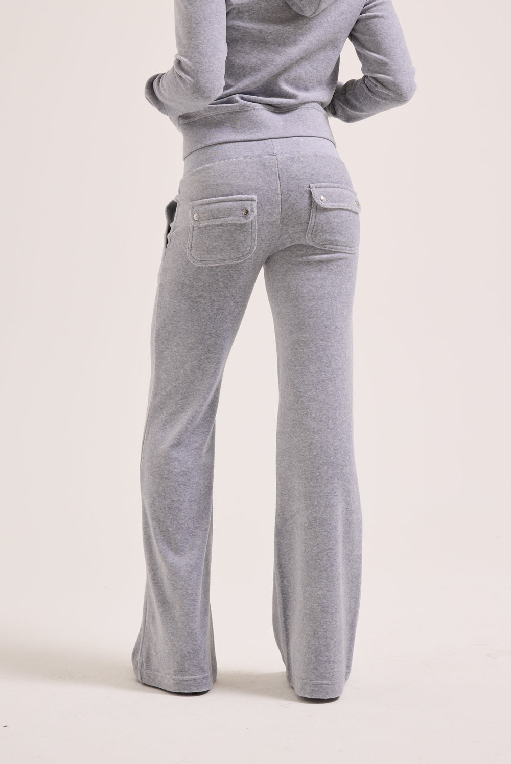 Displays a model wearing the Silver Marl Low Rise 'Juicy' branded cotton velour track pants