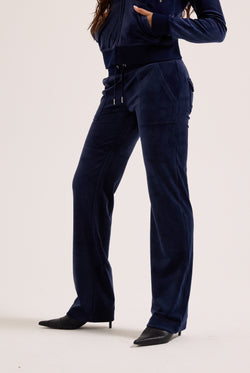 Navy blue outfit with pants and a top on a white background