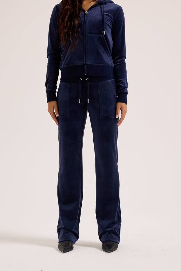Navy blue tracksuit worn by a person on a white background