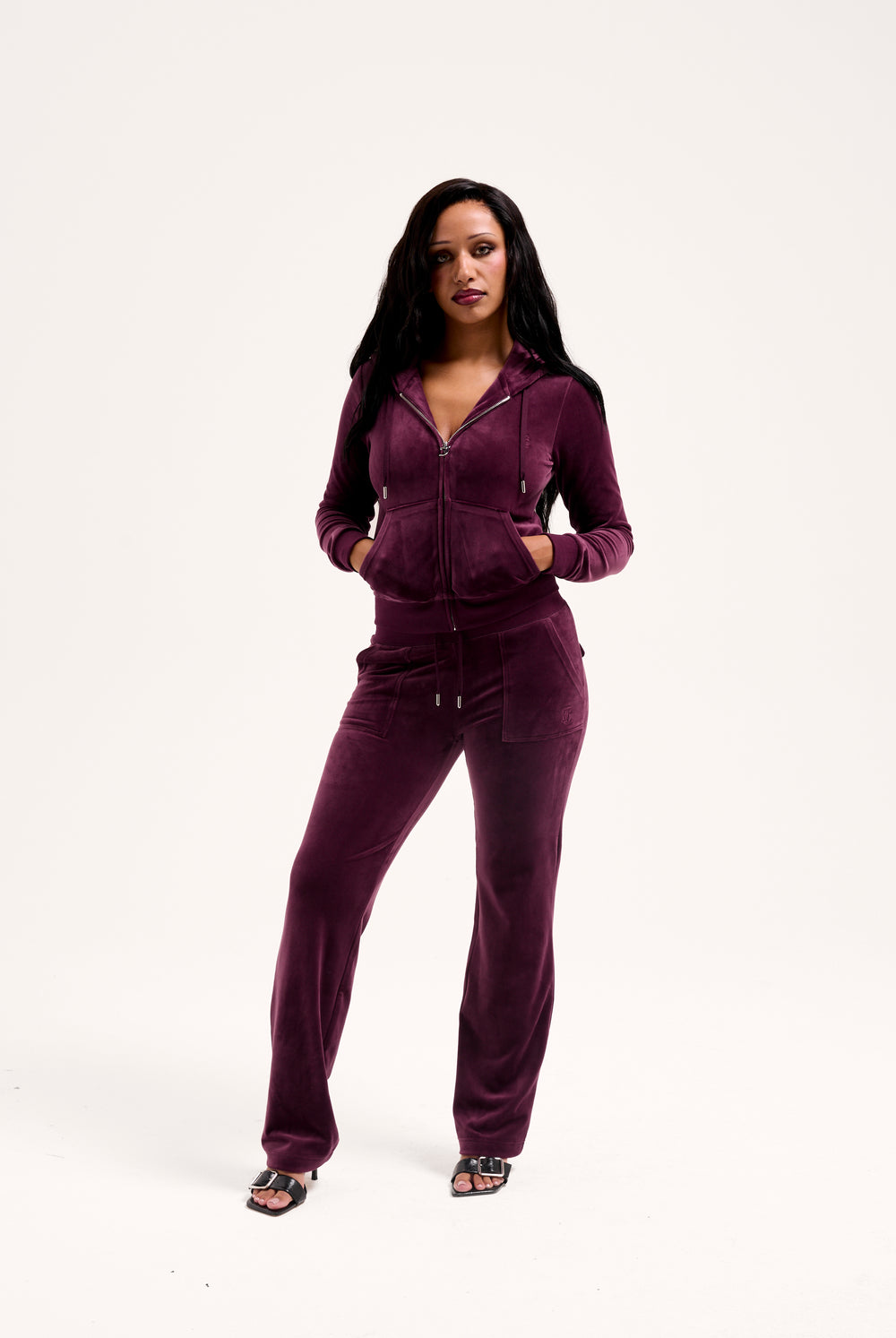 Displays a model wearing the Wine-tasting classic 'juicy' branded velour del ray pocketed 