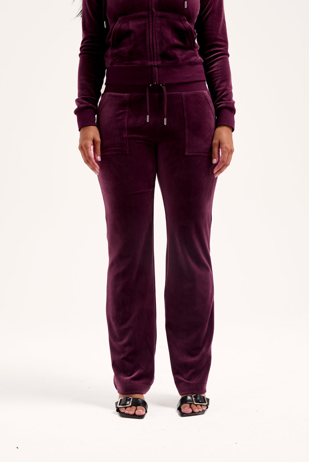 Displays a model wearing the Wine-tasting classic 'juicy' branded velour del ray pocketed 