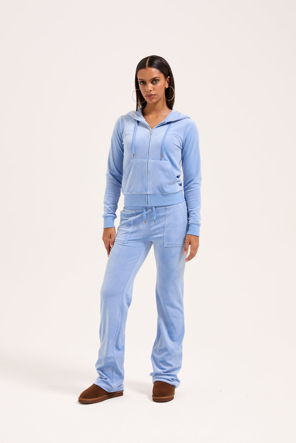 Displays a model wearing the Della Robia classic 'Juicy' branded velour del ray pocketed bottoms 