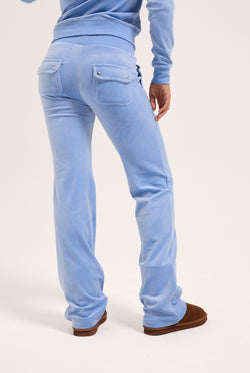 Displays a model wearing the Della Robia classic 'Juicy' branded velour del ray pocketed bottoms 
