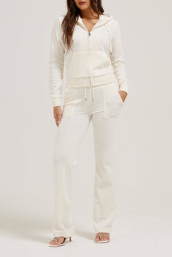 Displays a model wearing the cream classic 'Juicy' branded velour Robertson hoodie 