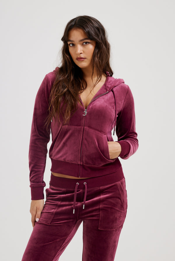 Displays a model wearing the Tawny Port 'Juicy' branded classic velour Robertson hoodie