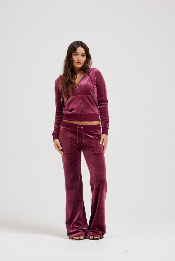 Displays a model wearing the Tawny Port 'Juicy' branded classic velour Robertson hoodie