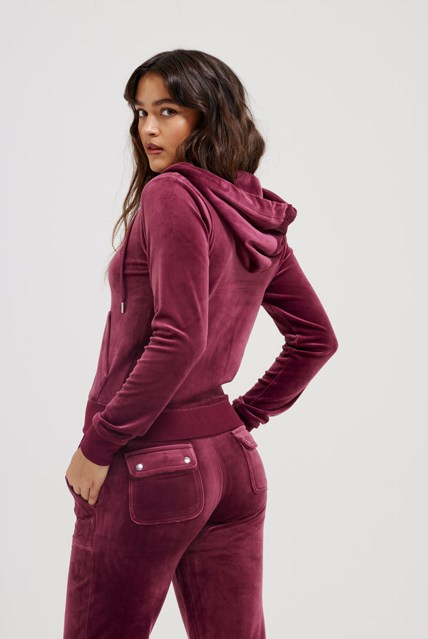 Displays a model wearing the Tawny Port 'Juicy' branded classic velour Robertson hoodie